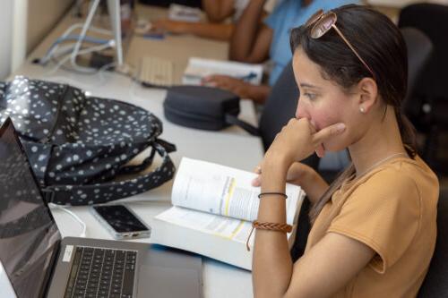 Student researching and working on a laptop